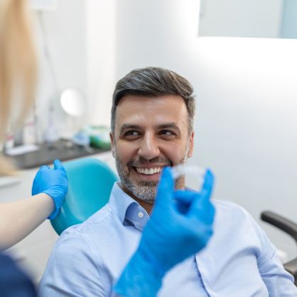 man smiling in dentists chair