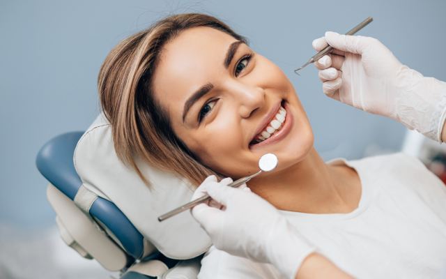 man smiling in dentists chair