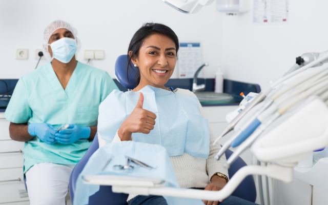 man smiling in dentists chair